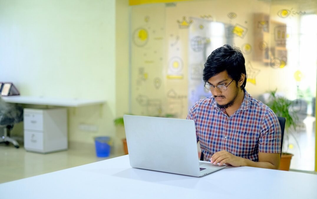 Data Entry Job 2026: Real या Fake? पूरी सच्चाई + Apply Guide woman in blue and white checkered shirt using macbook