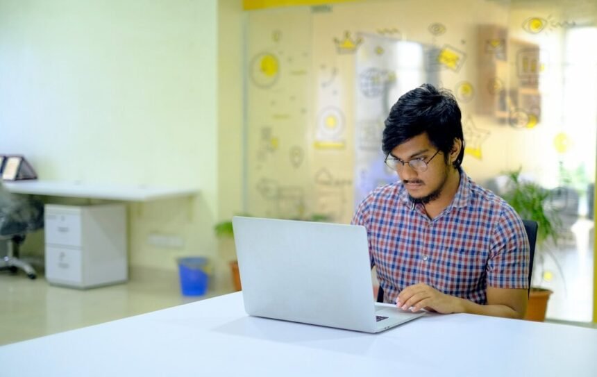 Data Entry Job 2026: Real या Fake? पूरी सच्चाई + Apply Guide 1 woman in blue and white checkered shirt using macbook